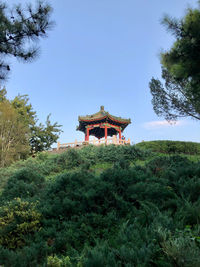 Built structure on field against sky