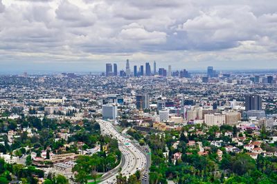 High angle view of cityscape against cloudy sky