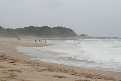 Scenic view of beach against clear sky