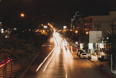 Cars on illuminated street at night