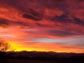 Scenic view of dramatic sky over silhouette landscape