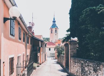 Street amidst buildings against sky in city