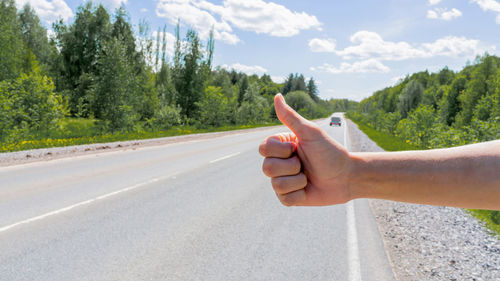 Cropped hand of man holding car