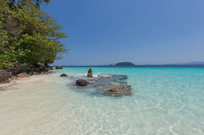 Scenic view of sea against clear blue sky