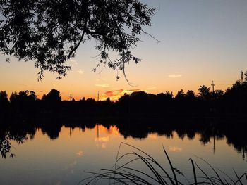 Scenic view of lake against orange sky