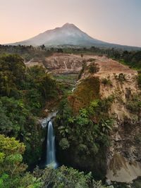 Scenic view of waterfall against sky at merapi mountain indonesian