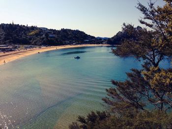 View of calm beach against clear sky