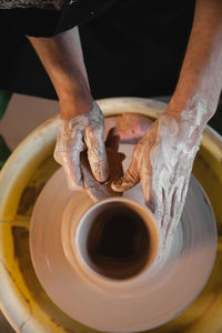 Cropped image of man making pottery at workshop