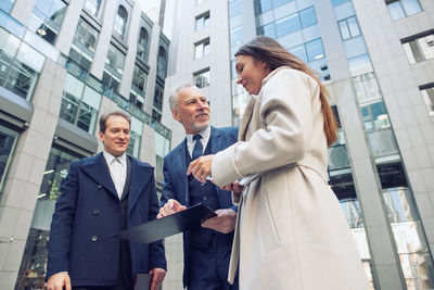 Low angle view business people standing outdoors