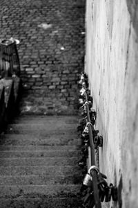 Close-up of bicycle on footpath against wall