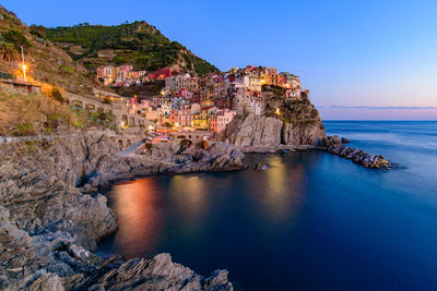 Scenic view of sea by town against sky