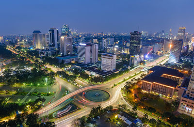 High angle view of illuminated city buildings at night