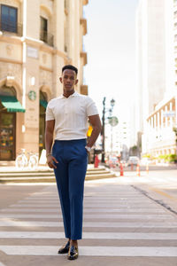 Portrait of young man standing in city