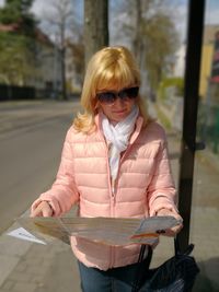 Portrait of woman wearing sunglasses standing outdoors