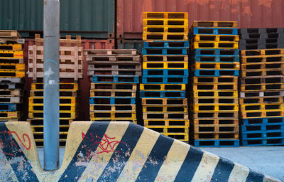 Stack of multi colored chairs in building