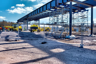Construction site in city against sky
