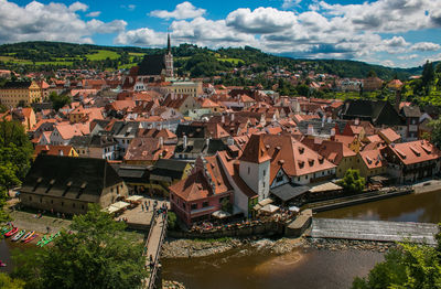 High angle view of townscape by river in city