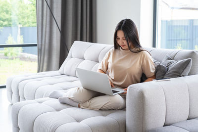 Young woman shopping online at home