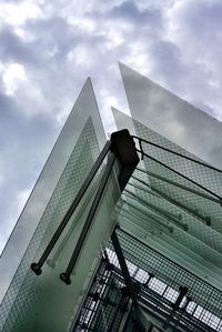 Low angle view of modern building against cloudy sky