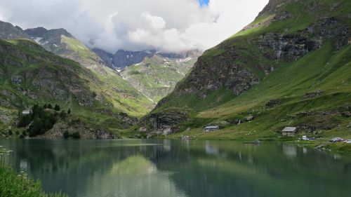 Scenic view of lake and mountains against sky