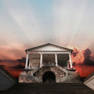 Traditional building against sky during sunset