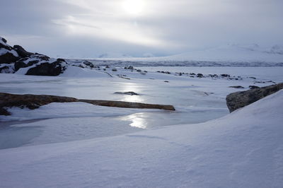 Scenic view of frozen lake against sky during winter