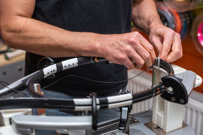 Midsection of man working at workshop