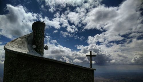 Low angle view of built structure against cloudy sky