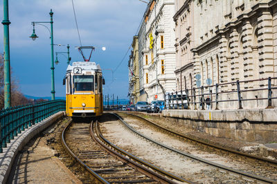 Railroad tracks against sky in city