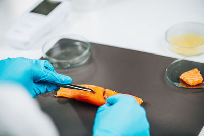 Food quality control of sea fish. quality control inspector analyzing salmon in a laboratory.