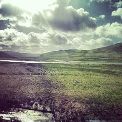 Scenic view of landscape against cloudy sky