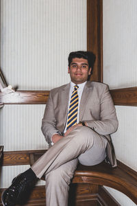 Portrait of young businessman sitting at home