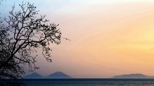 Scenic view of sea against orange sky