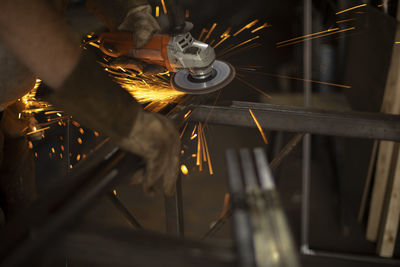 Close-up of man working on metal in factory