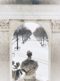 Rear view of statue against snow during winter