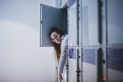 Portrait of young woman relaxing in locker