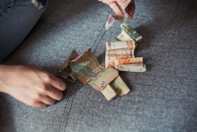 Midsection of woman holding paper currency