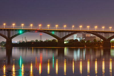 Night city bridge lighting. beautiful reflection of night lights on water surface. long exposure