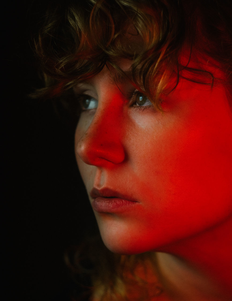 CLOSE-UP PORTRAIT OF WOMAN WITH RED EYES