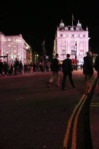 Group of people in front of building at night