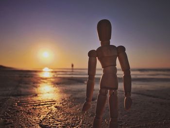 Rear view of shirtless man on beach