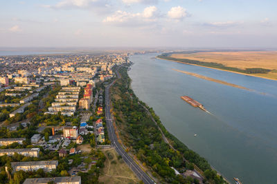High angle view of buildings by sea against sky