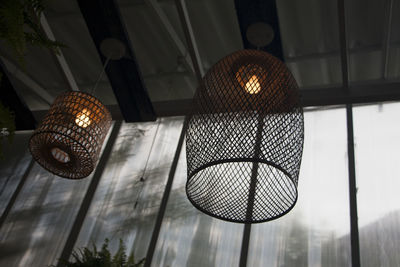 Low angle view of illuminated pendant lights hanging from ceiling