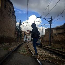 Railroad track against cloudy sky