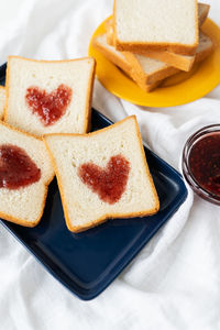 Toast on which the heart is made of jam. surprise breakfast concept in bed. 