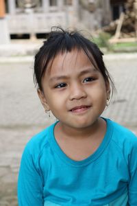 Girl wearing blue t-shirt looking away outdoors