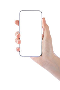 Close-up of hand holding smart phone over white background