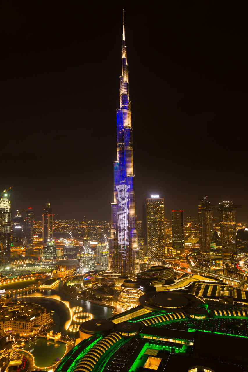 ILLUMINATED CITY BUILDINGS AT NIGHT