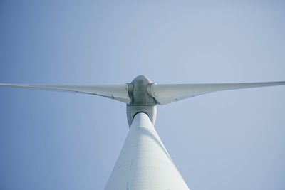 Low angle view of wind turbine against clear sky