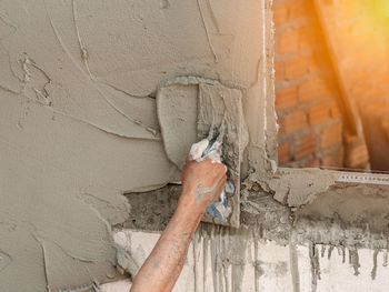 Close-up of hand on metal wall